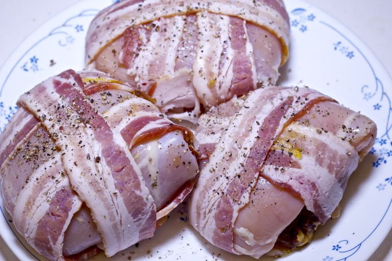 Grilled bacon-wrapped stuffed chicken breasts ready for the grill