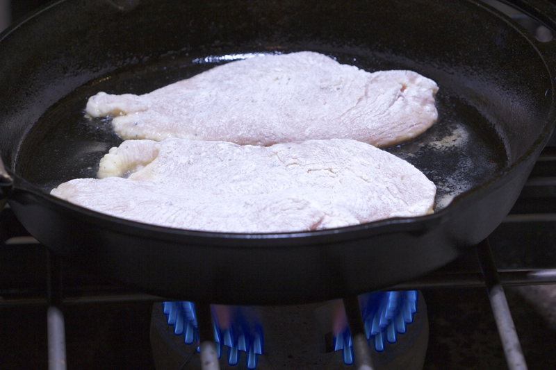 Floured Chicken Scaloppine in Cast iron skillet