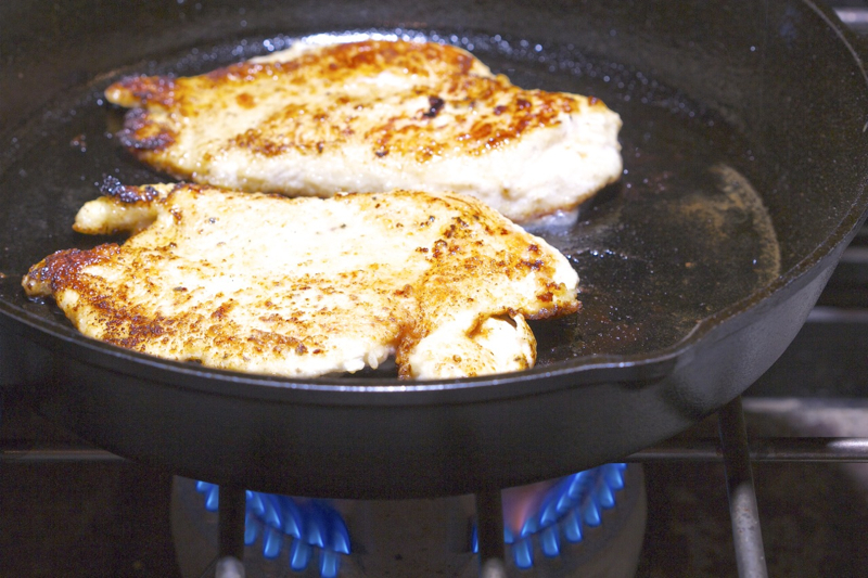 Browning the Orange-Olive Chicken Scaloppine in a Cast iron skillet