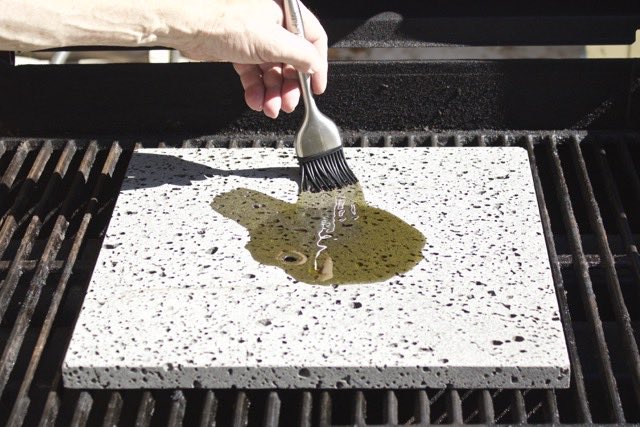 Brushing out the Olive Oil on the Island Grillstone | Cooking-Outdoors.com | Gary House